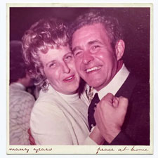 Polaroid of older couple embracing each other.