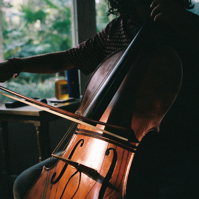 Close-up of Jordi playing the cello, with Jordi in silhouette.